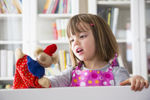 Girl At Home Playing Puppet Theater