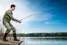 Fisherman Catching Fish Angling At The Lake