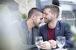 © Westend61 - Gay couple sharing an intimate moment at a restaurant