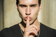 © theartofphoto - Handsome man making a shushing gesture