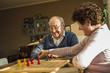© Westend61 - Senior couple playing ludo