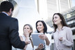 © Westend61 - Businessman and three women with digital tablet in the city