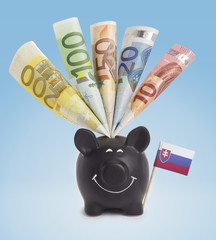 Various european banknotes in a happy piggybank of Slovakia.(ser