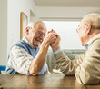 © Westend61 - Two senior friends arm wrestling