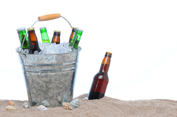 Wall Mural - Assorted beer bottles in a bucket of ice in the sand