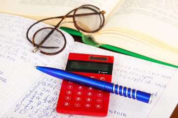 Back to school - blackboard with pencil-box and school equipment on table