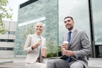 Sticker - smiling businessmen with paper cups outdoors