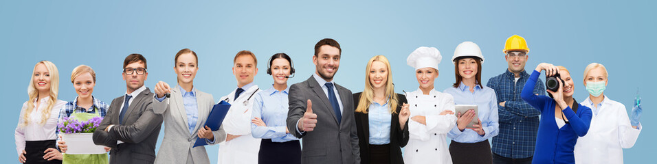 Canvas Print - happy businessman over professional workers