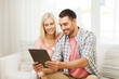 © Syda Productions - smiling happy couple with tablet pc at home