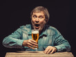 The screaming man in denim shirt with glass of beer