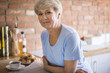 © gpointstudio - Mature woman standing in the kitchen