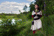 © Sloniki - Sad pretty farmgirl looking far away near river.