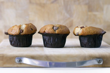 Trio Of Chocolate Chip Muffins On Wooden Board With Space For Copy Or Type