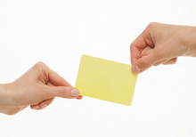Two Hands Pull In Different Directions An Yellow Card