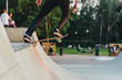 skateboarder at skate park on the ramp to perform tricks on the board in the light of the setting sun. soft focus and beautiful bokeh in the background.