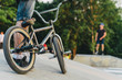 BMX rider on a bike is ready to perform a trick on a ramp in the summer skatepark. soft focus and beautiful bokeh