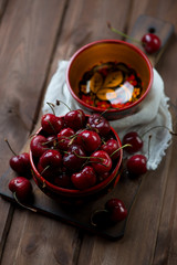 Wall Mural - Ripe cherries over rustic wooden background, selective focus