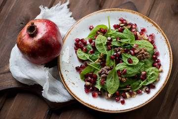 Sticker - Fresh spinach, pomegranate seeds and walnuts salad, close-up