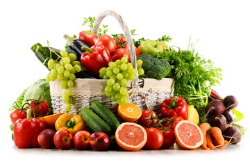 Wall Mural - Organic vegetables and fruits in wicker basket isolated on white