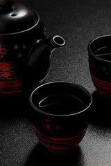 black teacups and pot