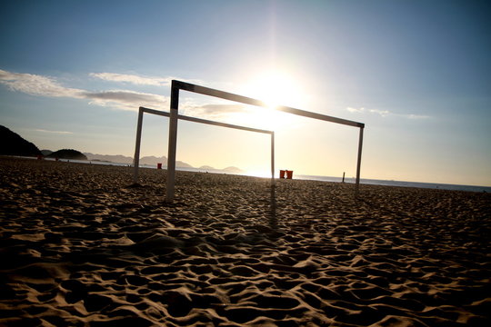 two goals with the sun and the ocean in the background at the copacabana beach in rio de janeiro, br