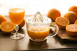 Fresh squeezed Orange juice in retro-stile hand squeezer 