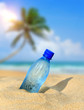 Bottle of the fresh water on sand