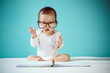 © DN6 - Cute Asian baby girl lying on stomach on bed, studio shot
