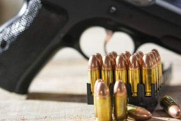 Group of Bullets and  Gun on wood  background