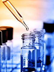 Wall Mural - laboratory research, dropping chemical liquid to test tube