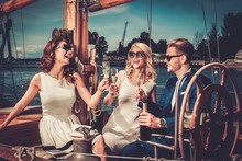 Stylish Wealthy Friends Having Fun On A Luxury Yacht