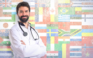 Doctor with his arms crossed over white background