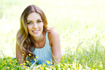 young woman in blue dress lying on grass