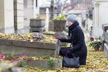Solitary Woman Visiting Relatives Grave.