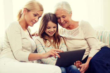 smiling family with tablet pc at home