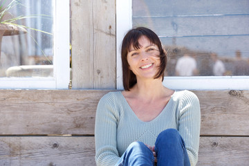 Wall Mural - Happy middle aged woman smiling outdoors