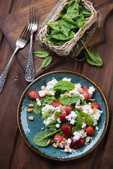 Wall Mural - Salad with spinach, strawberry, cheese and peanuts, top view