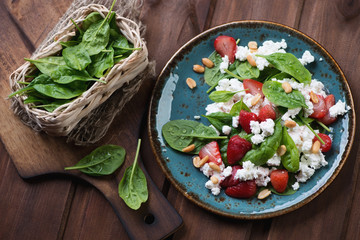 Wall Mural - Salad with strawberries, spinach leaves and cheese, top view