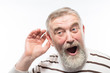 © kostyha - an old man with a beard is hard of hearing, health problems