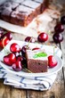 a piece of homemade chocolate brownie dessert with a cherry
