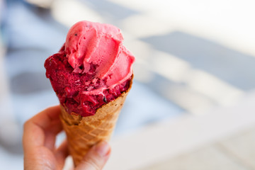 Raspberry sorbet in a fresh waffle cone