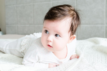 portrait of cute caucasian little baby girl in backlight