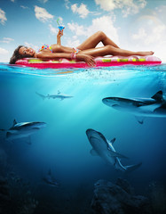 Wall Mural - Summer. Vacation. Woman hanging out on air mattress. With underwater part
