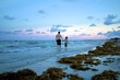 Father and son walking on the beach at sunset, South Beach Florida