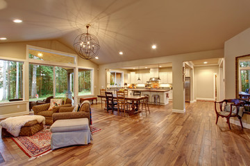 Well lit dinning room with connected living room.