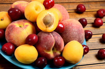 Poster - Plate with variety fruits on table