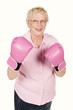 Portrait of grandmom wearing pink boxing gloves isolated on white