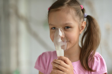 Wall Mural - Lovely little girl with inhaler