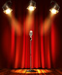 Stage with red curtians, microphone and spotlight.