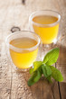 herbal sage tea with green leaf in glass cup